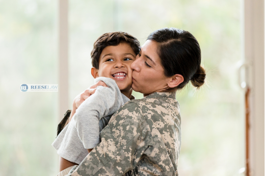 Military mother holding and kissing her young son, illustrating child custody considerations for families working with a Fairfax, VA, military divorce lawyer.